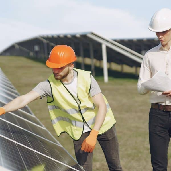 Foreman and businessman at solar energy station